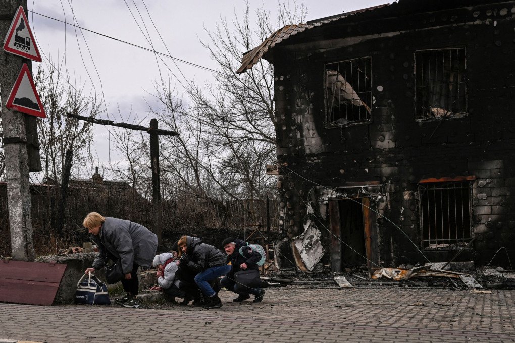 People take cover from shelling in the city of Bucha, west of Kyiv, March 4, 2022. Photo by ARIS MESSINIS/AFP via Getty Images