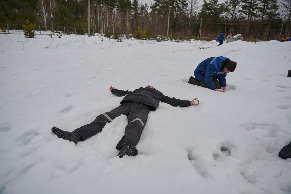 A released defender makes a snow angel after being freed from Russian captivity, March 6, 2026, undisclosed location, Ukraine. Photo by Mykyta Shandyba, UNITED24 Media