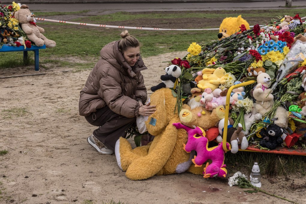 APRIL 6, 2025: A woman cries while petting a stuffed animal left at the playground where children were killed by a Russian missile in Kryvyi Rih, Ukraine, on April 4. Local residents from across the city brought flowers, toys, and sweets to the site. (Photo: Oksana Parafeniuk via Getty Images)