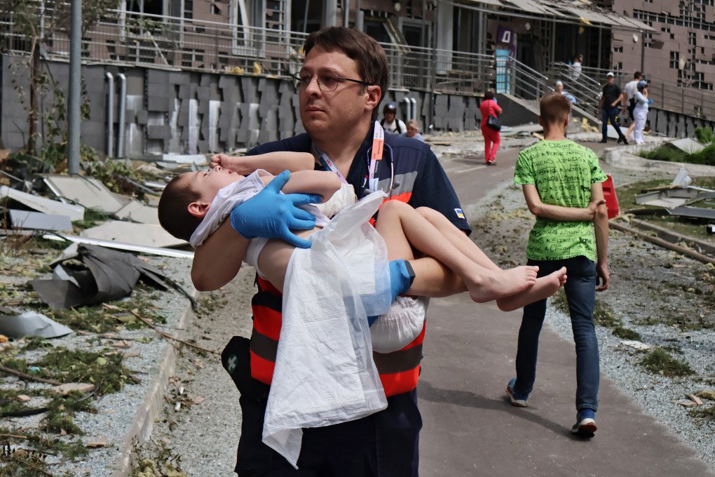 A medical worker carries in arms a child amid debris of Kyiv Okhmatdyt Children’s Hospital, partially destroyed by a Russian missile strike on July 8, 2024. (Photo by Oleksandr Gusev/Global Images Ukraine via Getty Images) A medical worker carries in arms a child amid debris of Kyiv Okhmatdyt Children’s Hospital, partially destroyed by a Russian missile strike on July 8, 2024. (Photo by Oleksandr Gusev/Global Images Ukraine via Getty Images)
