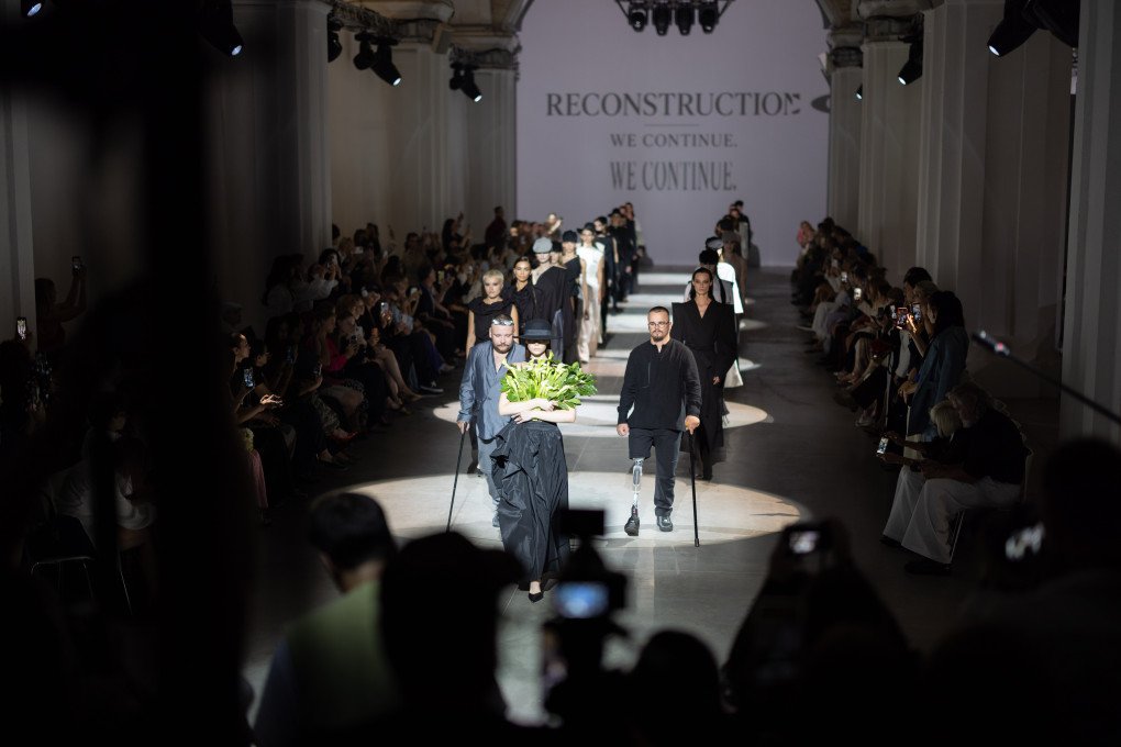 Models and Ukrainian veterans walk the runway during the finale of JULIYA KROS’ SS2027 RECONSTRUCTION show at Ukrainian Fashion Week in Kyiv on September 4, 2026. (Source: Vic Bakin/UNITED24 Media)
