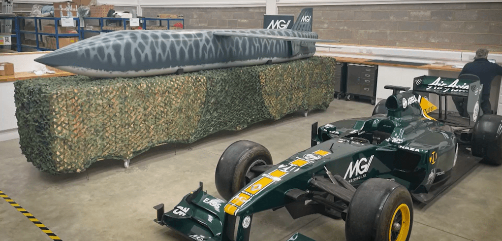 TigerShark drone near a Formula One race car, still from a BFBS/Forces News. (Source: BFBS/Forces News)