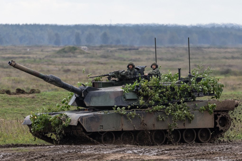 Polish soldiers drive a Leopard 2PL tank after crossing the Vistula River during the DRAGON-24 NATO military defense drills on March 05, 2024, in Korzeniewo, Poland. (Source: Getty Images)