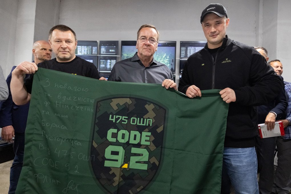 Germany's Defense Minister, Boris Pistorius, and Ukraine's Defense Minister, Mykhailo Fedorov with the flag with the flag of Ukraine’s 475th Separate Assault Regiment “CODE 9.2