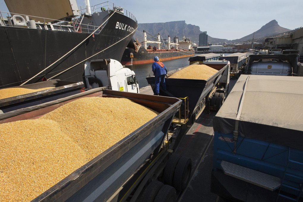 A dock worker checks trucks filled with imported corn maize before leaving the dockside at the city port in Cape Town, South Africa. (Photo: Halden Krog via Getty Images)