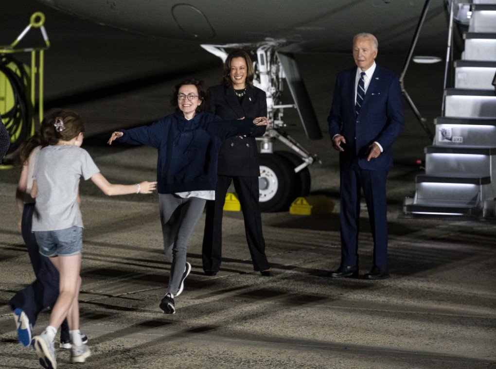US President Joe Biden and Democratic presidential candidate, US Vice President Kamala Harris embrace the family of freed prisoner Alsu Kurmasheva after she arrived at Joint Base Andrews on August 1, 2024 at Joint Base Andrews, Maryland. (Source: Getty Images) US President Joe Biden and Democratic presidential candidate, US Vice President Kamala Harris embrace the family of freed prisoner Alsu Kurmasheva after she arrived at Joint Base Andrews on August 1, 2024 at Joint Base Andrews, Maryland. (Source: Getty Images)