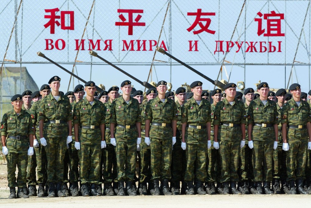 Russian soldiers are reviewed by Russian Defense Minister Sergei Ivanov and his Chinese counterpart Cao Gangchuan (not in picture) during the closing ceremony of a Sino-Russian military exercise on August 25, 2005, in eastern China’s Shandong Province. The slogan behind them reads “For the name of peace and friendship”. (Source: Getty Images) Russian soldiers are reviewed by Russian Defense Minister Sergei Ivanov and his Chinese counterpart Cao Gangchuan (not in picture) during the closing ceremony of a Sino-Russian military exercise on August 25, 2005, in eastern China’s Shandong Province. The slogan behind them reads “For the name of peace and friendship”. (Source: Getty Images)