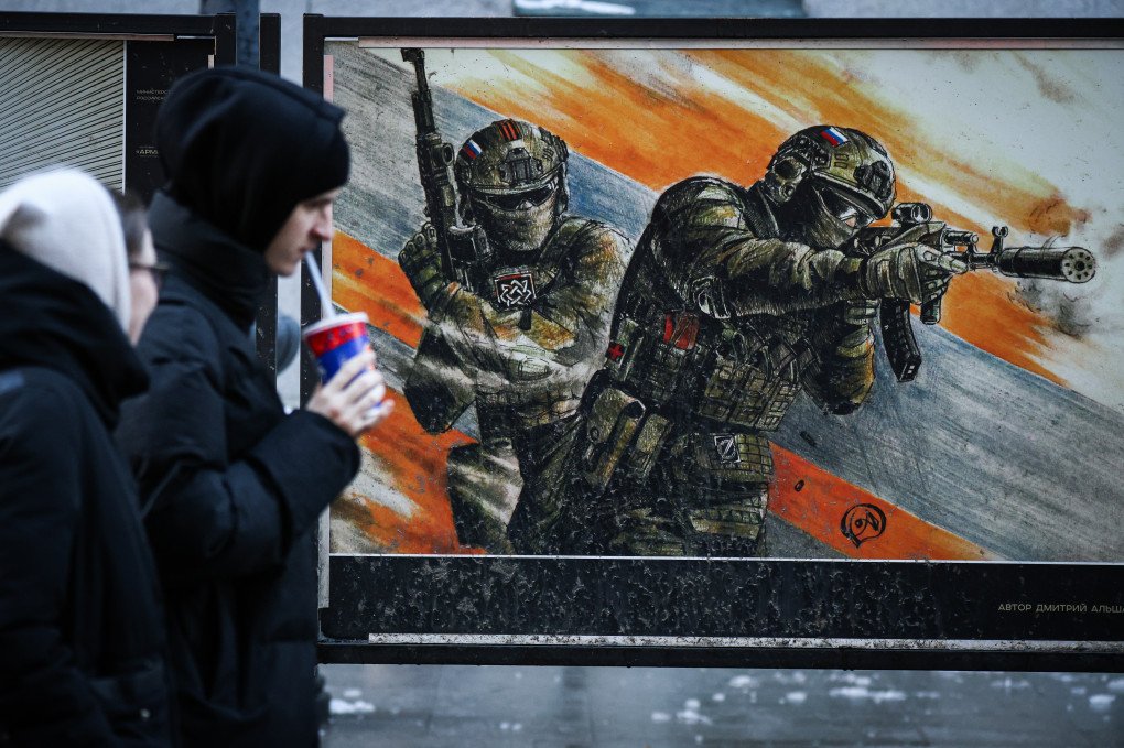 People walk past a poster depicting Russian servicemen at an exhibition dedicated to the its war against Ukraine on Bolshaya Morskaya Street, St. Petersburg, Russia, February 20, 2025.Photo by Artem Priakhin/SOPA Images/LightRocket via Getty Images