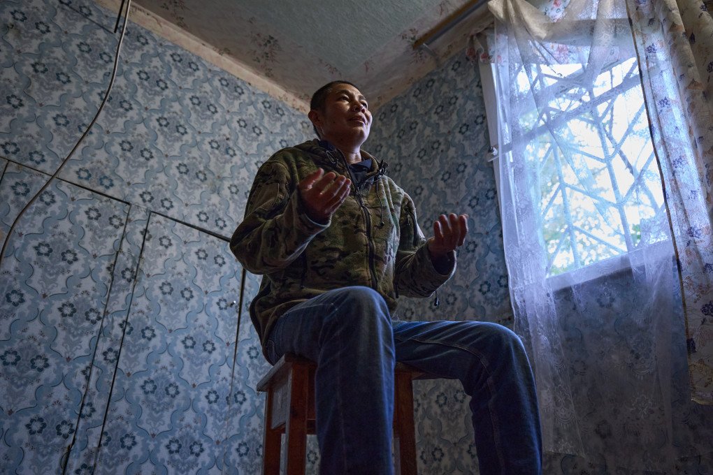 Peruvian prisoner of war (POW) Americo Valdivia Teco details the conditions he faced upon arriving in Moscow. Valdivia Teco explained that his passport was immediately confiscated by the recruiting agent, who isolated him and his travel companions in a hotel with only one meal a day before forcing them to sign military contracts they could not understand. (Photo: Mykyta Shandyba / UNITED24 Media) Peruvian POW Americo Valdivia Teco sits on a stool and gestures with both hands during an interview, explaining how a Russian agent confiscated his passport and confined him to a hotel before forcing him to sign an illegible military contract.