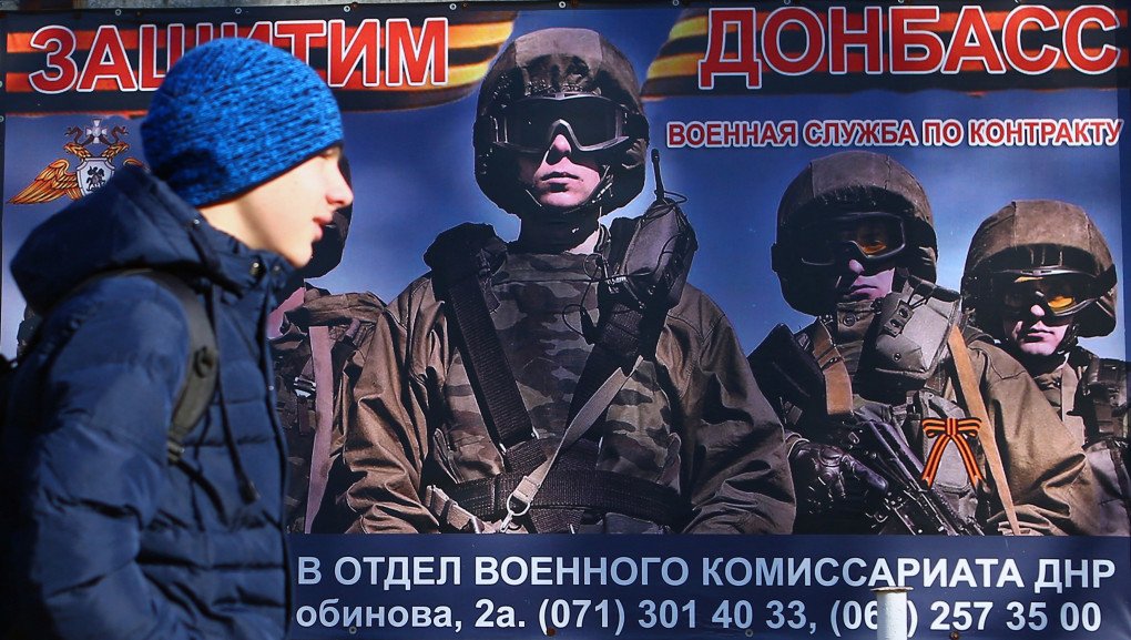 A boy walks past an advertising billboard with a poster that reads “Defend Donbas” calling to serve in the self-proclaimed People Republic of Donetsk army, in Donetsk on November 15, 2018. (Source: Getty Images) A boy walks past an advertising billboard with a poster that reads “Defend Donbas” calling to serve in the self-proclaimed People Republic of Donetsk army, in Donetsk on November 15, 2018. (Source: Getty Images)