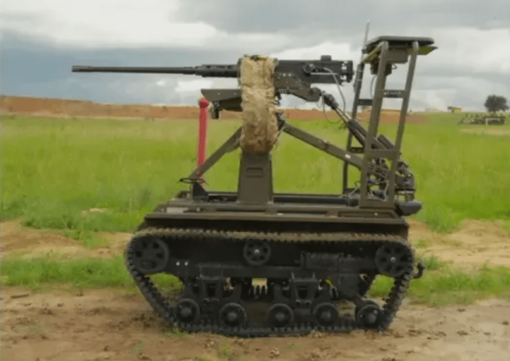 A side profile view shows the tracked Tanchik Droid 12.7 unmanned ground vehicle parked on dirt ground in an open field. (Source: Ministry of Defense of Ukraine) A side profile view shows the tracked Tanchik Droid 12.7 unmanned ground vehicle parked on dirt ground in an open field. (Source: Ministry of Defense of Ukraine)