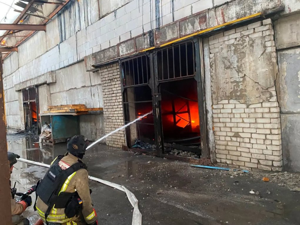 Emergency responders work to extinguish a fire at a Ukrainian Red Cross warehouse in Kherson after a Russian drone attack on August 23, 2026. (Source: Ukrainian Red Cross)
