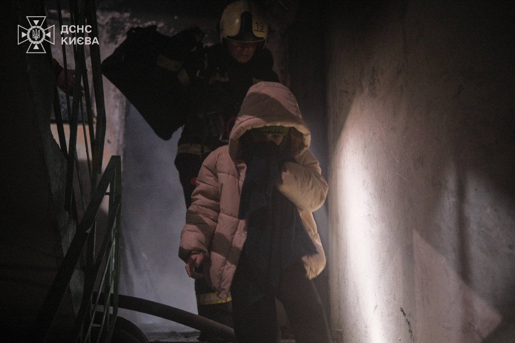 SES rescuer evacuates a civilian from a damaged house after a Russian airstrike on Kyiv, November 14, 2025. (Source: SES)