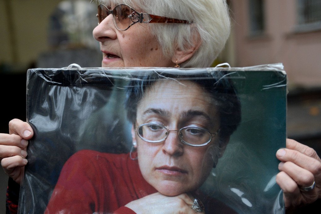 A woman holds a portrait of journalist Anna Politkovskaya during a rally marking the 10th anniversary of her murder. (Source: Natalia Kolesnikova via Getty Images)