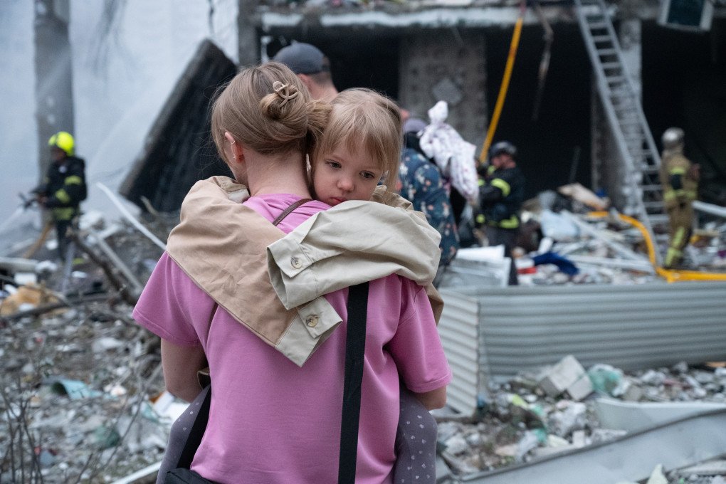 A girl hold to her mother near the residential building damaged during the Russian attack In Kyiv, Ukraine, on July 06, 2026. (Photo by Stringer/Anadolu via Getty Images) Russia Pounds Kyiv With Ballistic Missiles