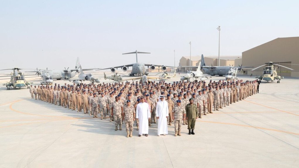 Qatari Sheikh Tamim bin Hamad Al Thani, Minister of State for Defense of Qatar, Khalid bin Mohammad Al Attiyah, and Qatari Chief of the Army Mubarak Mohammed Al Khayareen pose for a photo with soldiers as part of their visit to the US Combined Air Operations Center of Qatar (CAOC) at Al Udeid Air Base in Doha, Qatar.