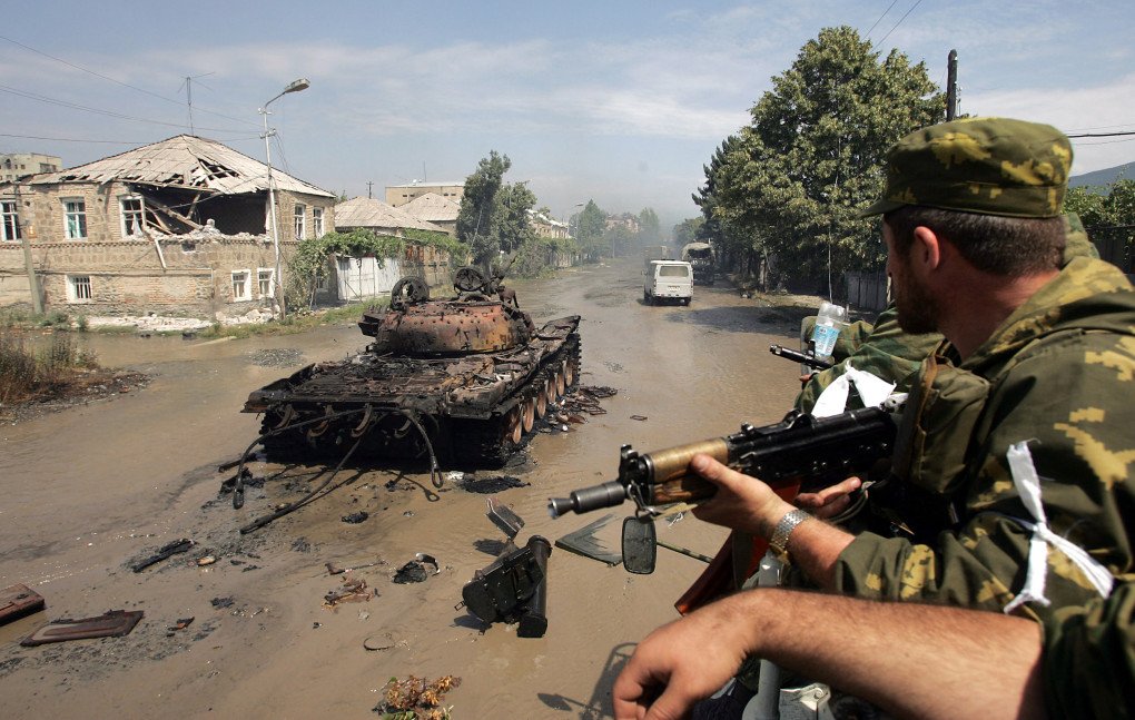 Russian soldiers ride an APC past a burnt-out Georgian tank in Tskhinvali, South Ossetia, Georgia, on August 11, 2008. (Photo by Dmitry Kostyukov via Getty Images) 