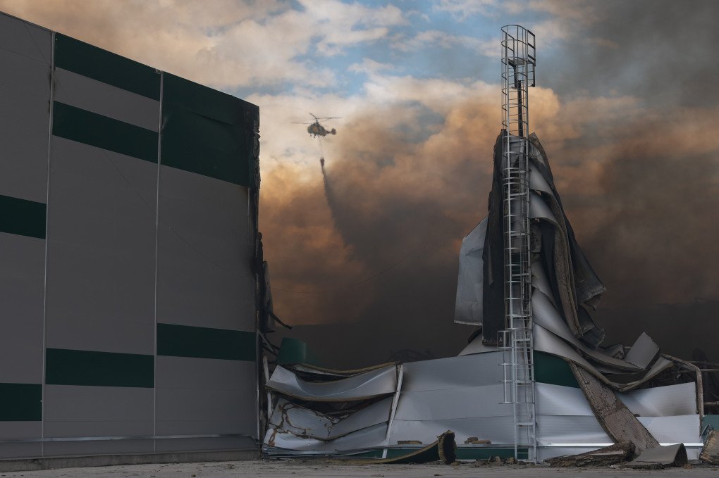 A helicopter extinguishes a fire in warehouses damaged by Russian drone strikes on August 27, 2026 in Kyiv, Ukraine. (Photo by Ivan Antypenko via Getty Images)