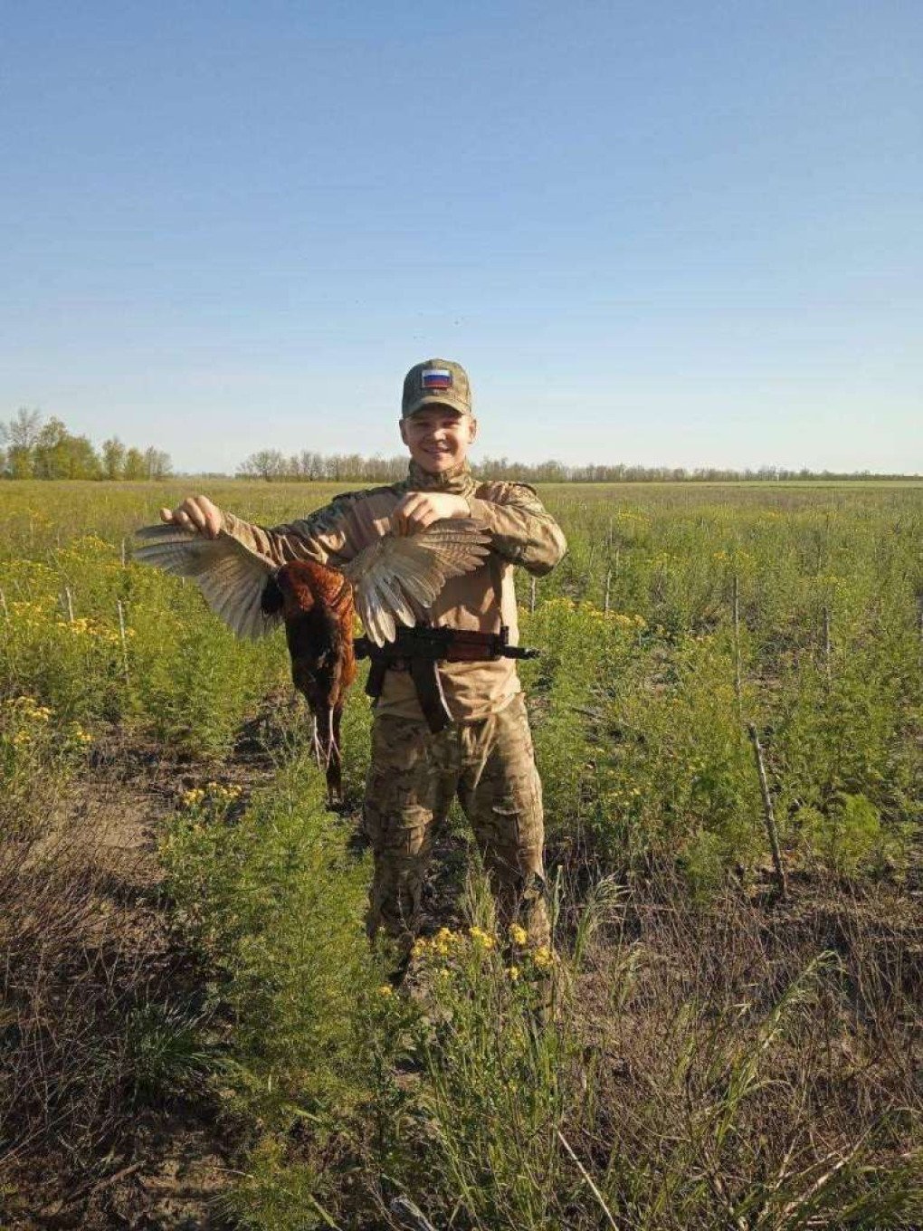 Russian soldier posing with a killed Common pheasant. (Source: UAnimals/ Facebook)