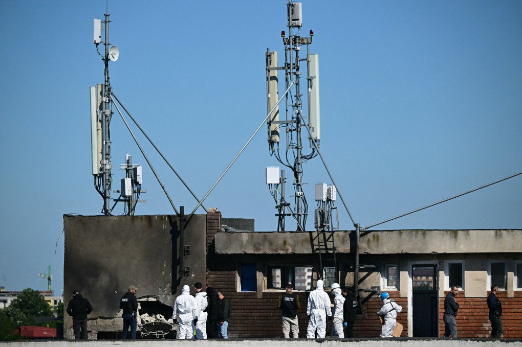 Police and forensic investigators examine the location of impact (L) after a Russian drone struck an apartment building in Galati, eastern Romania. (Photo by Daniel Mihailescu via Getty Images)