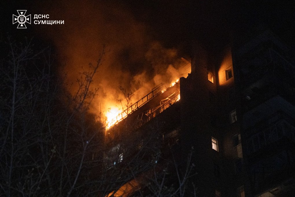 Flames and thick smoke pour from the upper floors of a 16-story residential building in Sumy after a Russian strike drone attack. (Source: DSNS)