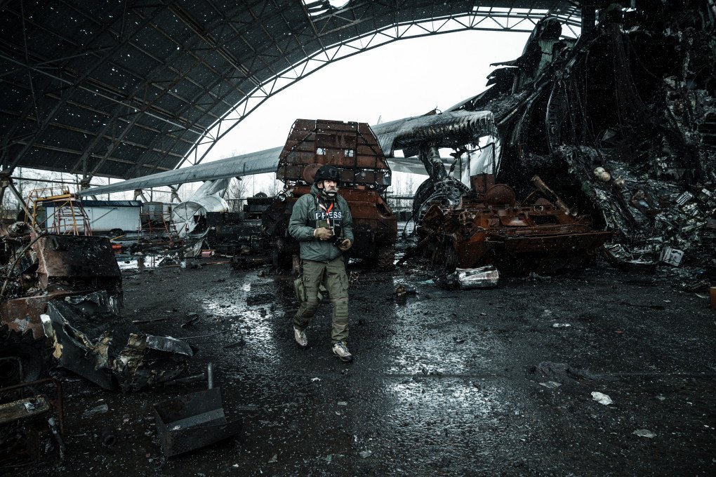 HOSTOMEL, UKRAINE - APRIL 3, 2022: Ukrainian documentary photographer Oleksandr Hliadielov is pictured taking photos of the aftermath of one of the first battles of Russia’s full-scale invasion of Ukraine, that started on the 24th of February, 2024 at the Antonov Airport. The photo shows the charred remains of the Antonov An-225 Mriya—the largest cargo aircraft in the world—destroyed by Russia after their failed attempt to capture the key Ukrainian airfield—just 12km from Kyiv. Surrounding the wreckage, remains of Russian military vehicles lie scattered. This was one of the defining moments that marked an escalation of the war that Russia started in 2014. (Photo by Serhii Mykhalchuk/Global Images Ukraine via Getty Images)