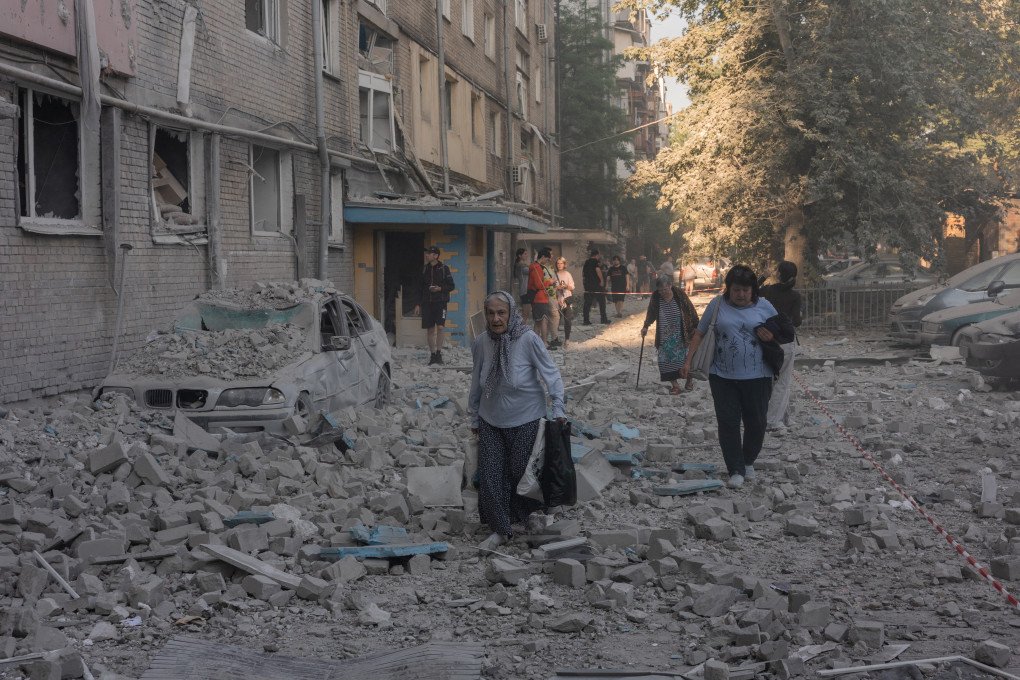 An elderly woman walks through the rubble at the site of a residential building damaged following a Russian air attack on the Ukrainian capital of Kyiv on July 2, 2026, amid the Russian invasion in Ukraine. A barrage of Russian missiles and drones killed at least 13 people in the Ukrainian capital of Kyiv, officials said on July 2, as Ukraine urged its allies to send more air defence systems. (Photo by Roman PILIPEY / AFP via Getty Images)