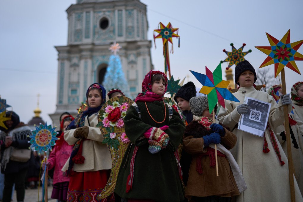 Children light up the festive streets of Kyiv. St. Sophia Bell Tower stands in the background.