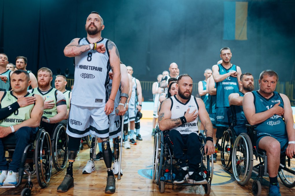 Ukrainian veteran Oleksii Prytula (#8) stands with hand over heart during the national anthem at the All-Ukrainian Wheelchair Basketball Tournament for veterans. Photo: Serhii Halushka, Come Back Alive Foundation Ukrainian veteran Oleksii Prytula (#8) stands with hand over heart during the national anthem at the All-Ukrainian Wheelchair Basketball Tournament for veterans. Photo: Serhii Halushka, Come Back Alive Foundation