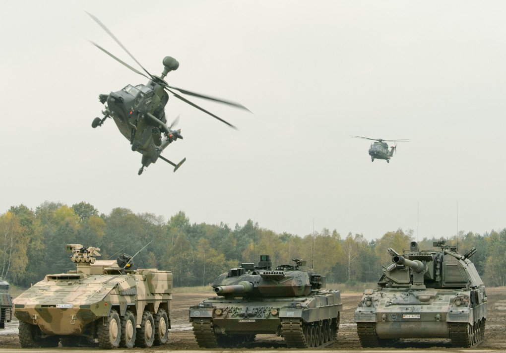 A combat helicopter Tiger (l-r) and a multipurpose helicopter NH90 fly across an armoured transporter vehicle Boxer (l-r), a combat tank Leopard 2 (center), and an armoured howitzer PzH 2000 in the military training area near Munster, Germany, 14 October 2016. (Source: Getty Images) A combat helicopter Tiger (l-r) and a multipurpose helicopter NH90 fly across an armoured transporter vehicle Boxer (l-r), a combat tank Leopard 2 (center), and an armoured howitzer PzH 2000 in the military training area near Munster, Germany, 14 October 2016. (Source: Getty Images)