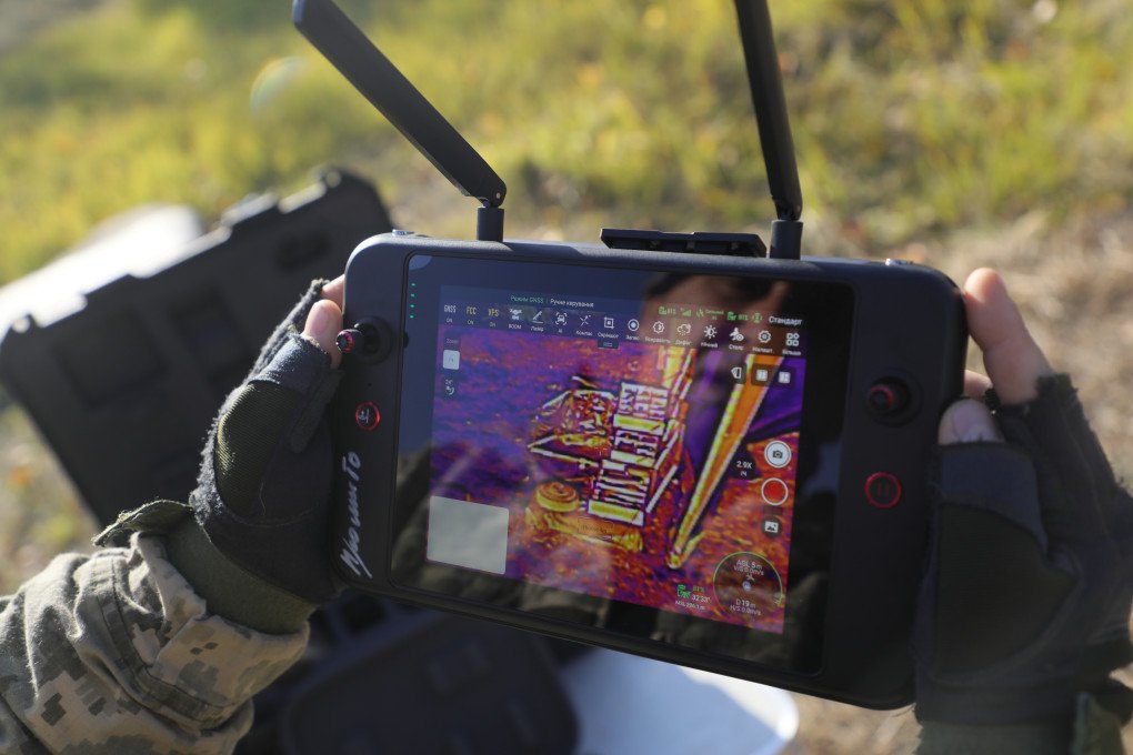A participant uses a remote control to operate an unmanned ground vehicle (UGV) that carries equipment during humanitarian demining training for war veterans in Kyiv, Ukraine, on October 30, 2025. (Photo by Ukrinform via Getty Images)