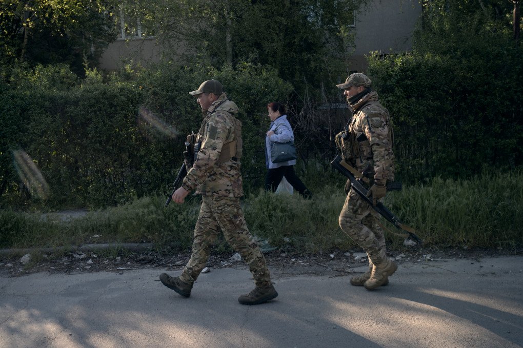 The twins, patrol the streets amongst local residents. Kherson, Ukraine, May 2026. Photo: Joshua Olley / UNITED24 Media.