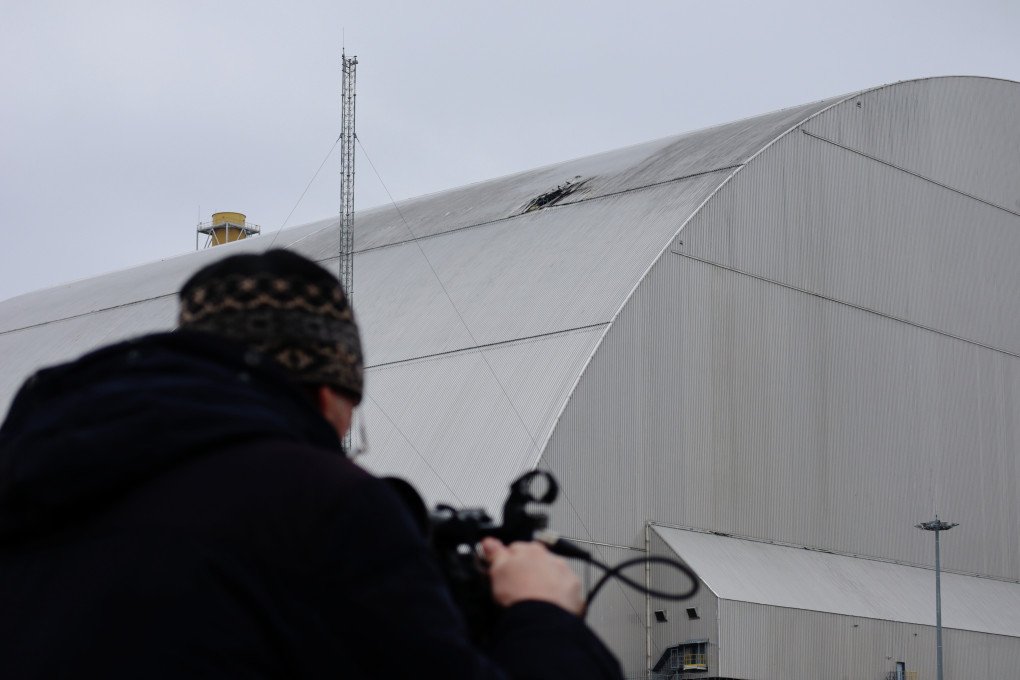 A journalist films a hole in a roof of the New Safe Confinement (Shelter) over the number 4 reactor unit at the Chоrnobyl Nuclear Power Plant, damaged by a Russian drone strike on April 12, 2025 in Chornobyl, Kyiv region, Ukraine. (Photo: Andriy Zhyhaylo via Getty Images) A journalist films a hole in a roof of the New Safe Confinement (Shelter) over the number 4 reactor unit at the Chоrnobyl Nuclear Power Plant, damaged by a Russian drone strike on April 12, 2025 in Chornobyl, Kyiv region, Ukraine. (Photo: Andriy Zhyhaylo via Getty Images)