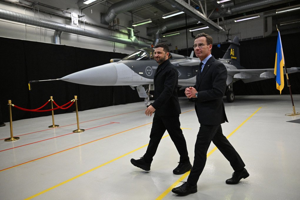 Swedish Prime Minister Ulf Kristersson and Ukrainian President Volodymyr Zelenskyy walk past a Gripen fighter jet after they delivered a joint press conference in Linköping, Sweden, on October 22, 2025. Photo by Jonathan Nackstrand/AFP via Getty Images)