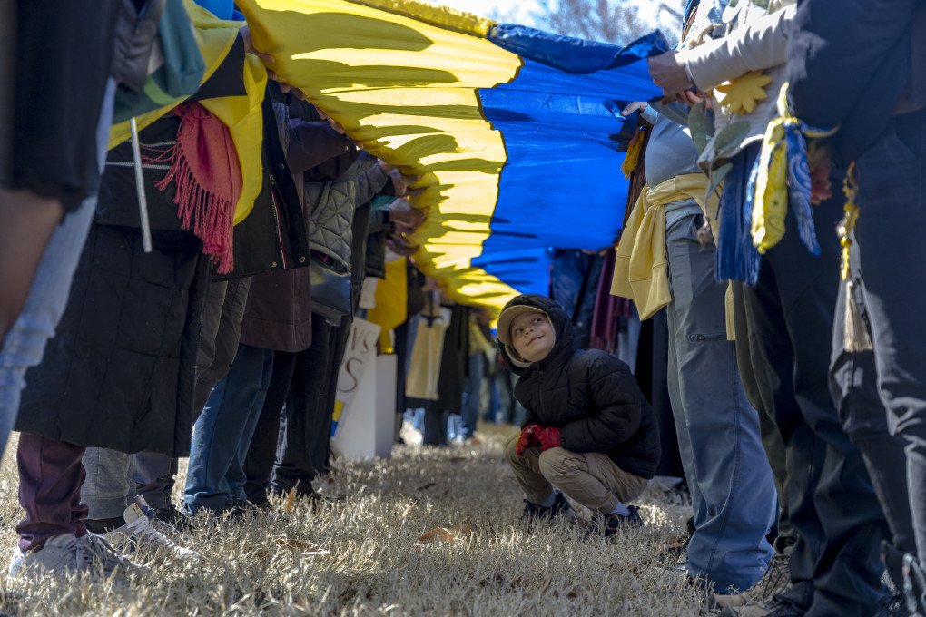 Demonstrators hold the world's largest Ukrainian flag at the Ellipse in Washington, DC, on March 8, 2025. (Photo: HANNA LEKA/Middle East Images/AFP via Getty Images)
