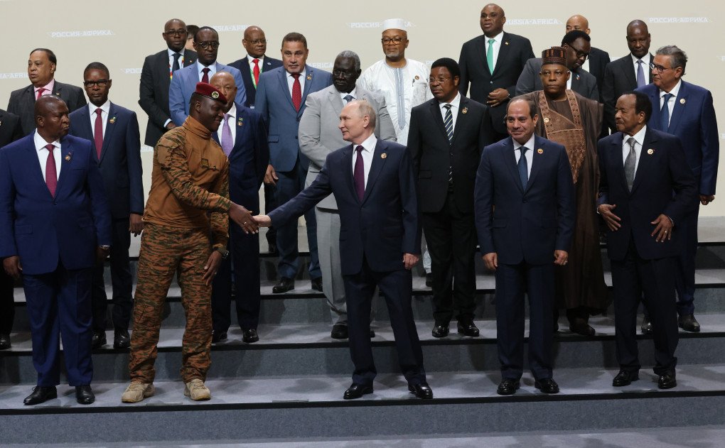 Russian leader Vladimir Putin (C) shakes hands with leader of Burkina Faso Ibrahim Traore (L) during a group photo with delegation's leaders of the Russia-African Summit, in Saint Petersburg, Russia. (Photo by Contributor via Getty Images)