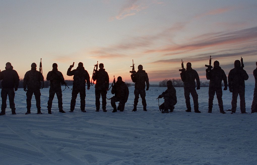 A unit within the the 1st Battalion “Wolfborn” of the 144th Special Operations Forces Center is silhouetted before the ceremony begins. March 2026. Photo by Joshua Olley/UNITED24 Media.