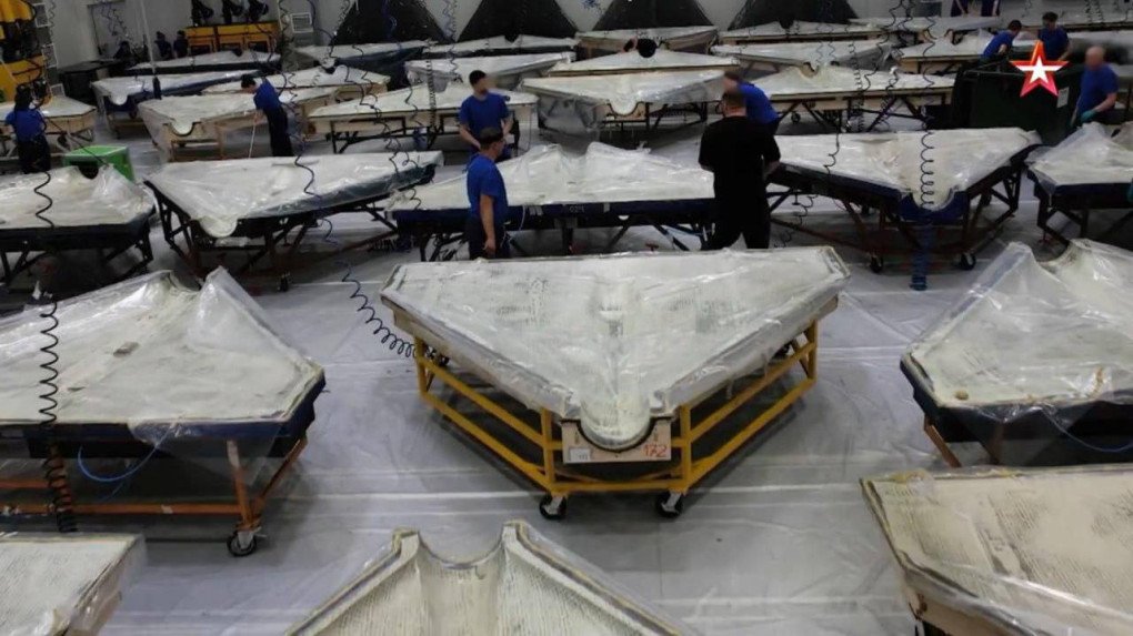 Las alas de los drones toman forma bajo las láminas de plástico mientras se procesan los materiales compuestos en la sección de moldeo de la fábrica. (Fuente: Zvezda TV) Las alas de los drones toman forma bajo las láminas de plástico mientras se procesan los materiales compuestos en la sección de moldeo de la fábrica. (Fuente: Zvezda TV)