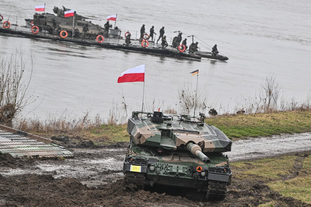 Polish soldiers drive a Leopard 2PL tank after crossing the Vistula River during the DRAGON-24 NATO military defense drills on March 05, 2024, in Korzeniewo, Poland. (Source: Getty Images)