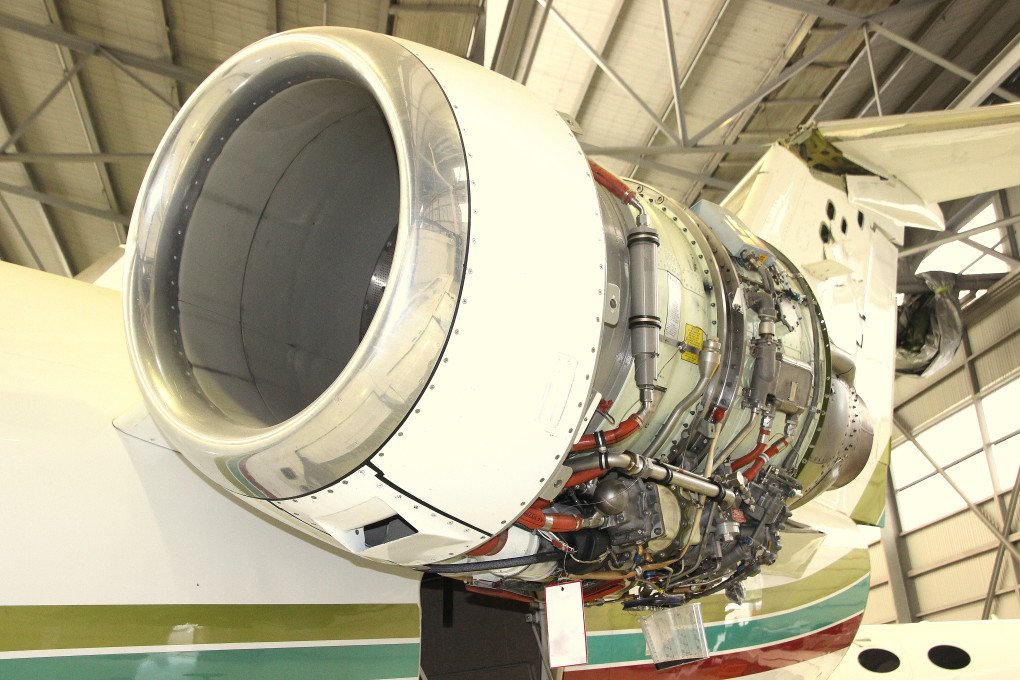 A Garrett TFE731 engine mounted on the left pylon of a Cessna 650 Citation VII undergoing maintenance, 2015.
