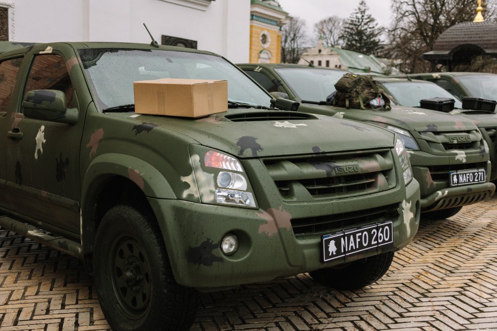 “Box on the hood, memes on the plates, supplies in the back.” Convoy NAFO 260, ready for handoff to the front. Source: 69th Sniffing Brigade.