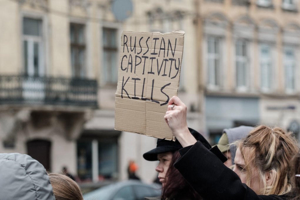 An activist holds a banner that reads 'Russian captivity kills' as servicemen, wounded veterans and relatives of Ukrainian POWs urge for the return of Ukrainian soldiers from Russian captivity during the rally on October 12, 2025 in Lviv, Ukraine. Photo: Les Kasyanov/Global Images Ukraine via Getty Images