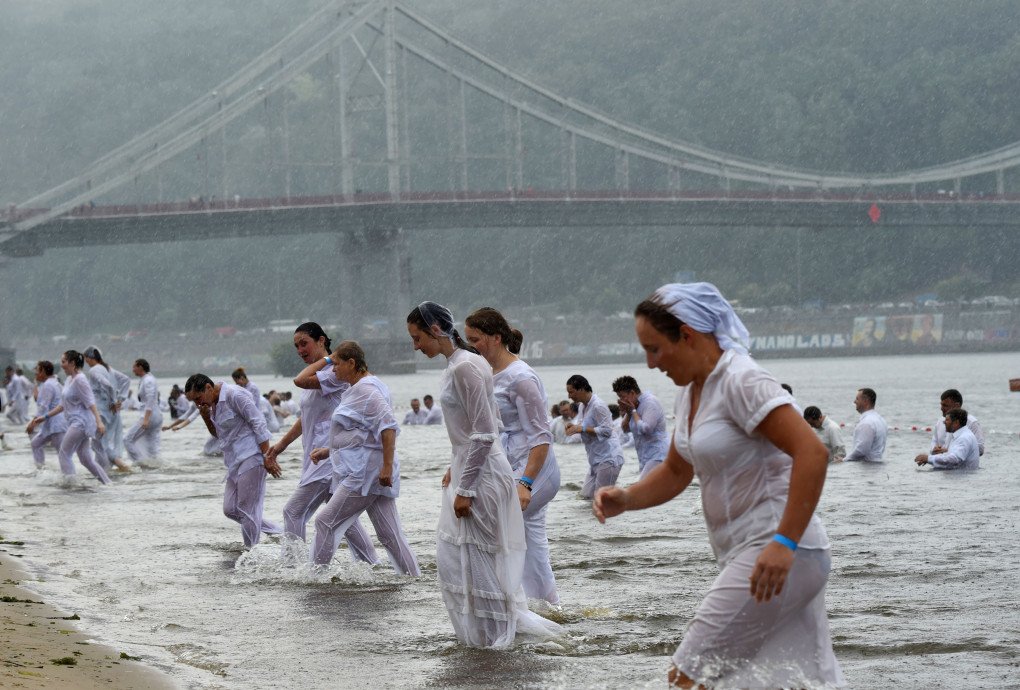 Ukrainian Evangelical Protestants take part in a mass baptism in the Dnipro River in Kyiv on July 22, 2018. About 500 people took part to mark the 1030th anniversary of the Christianization of the Kyivan Rus. (Photo credit should read SERGEI SUPINSKY/AFP via Getty Images) Ukrainian Evangelical Protestants take part in a mass baptism in the Dnipro River in Kyiv on July 22, 2018. About 500 people took part to mark the 1030th anniversary of the Christianization of the Kyivan Rus. (Photo credit should read SERGEI SUPINSKY/AFP via Getty Images)