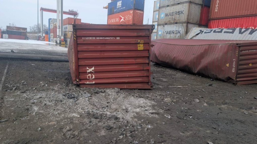 Overturned shipping containers at a port facility following an attack, with cargo infrastructure damaged and debris scattered across the terminal. (Photo: Oleksii Kuleba)