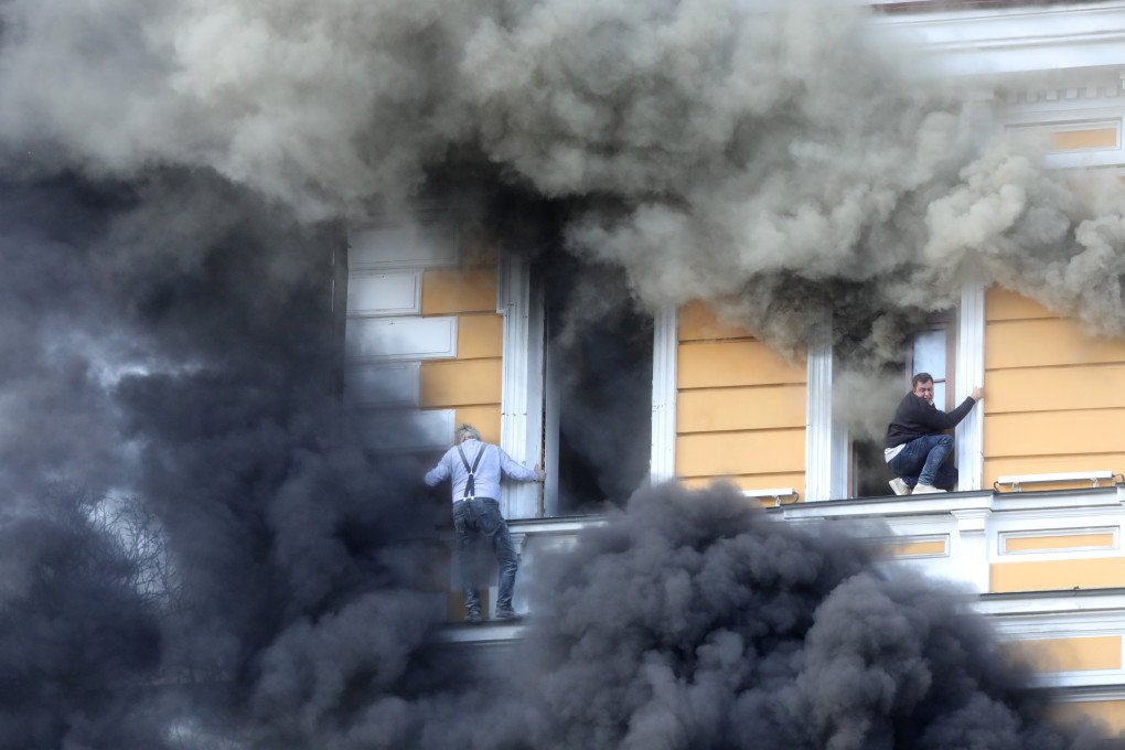 Two men attempt to escape from the National Academy of Sciences building, which is burning after being hit by a drone on September 28, 2026 in Kyiv, Ukraine. (Photo by Volodymyr Tarasov via Getty Images) Two men attempt to escape from the National Academy of Sciences building, which is burning after being hit by a drone on September 28, 2026 in Kyiv, Ukraine. (Photo by Volodymyr Tarasov via Getty Images)