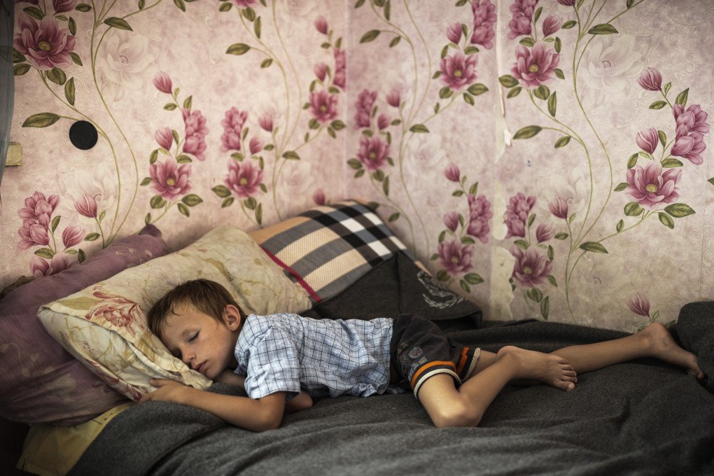 Kyrylo Hrynyk sleeping in his new home in the Poltava region, 2023. (Image: Anastasia Taylor-Lind) Kyrylo Hrynyk sleeping in his new home in the Poltava region, 2023. (Image: Anastasia Taylor-Lind)