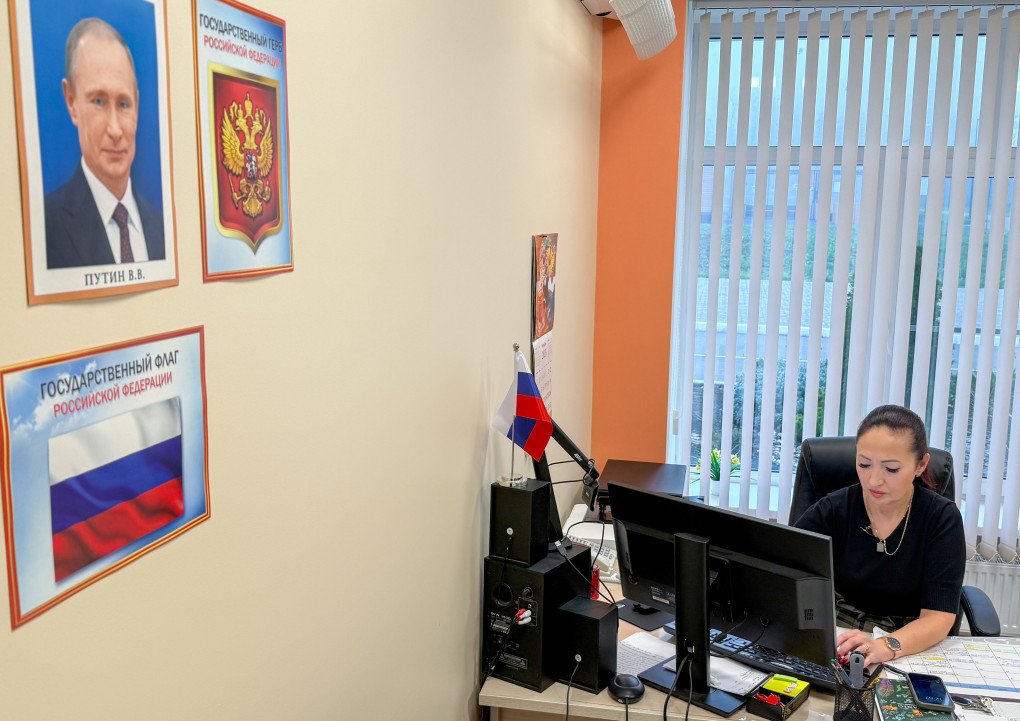 School director under Putin official portrait in an office, Mariupol, Ukraine. (Photo by Alexandre Spalaikovitch via Getty Images) School director under Putin official portrait in an office, Mariupol, Ukraine. (Photo by Alexandre Spalaikovitch via Getty Images)