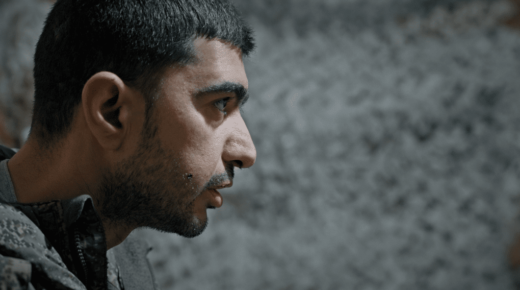 Arash Darbandi, an Iranian photographer, during an interview recounting how he was coerced into joining the Russian military after arriving in Russia for work. Photo: UNITED24 Media