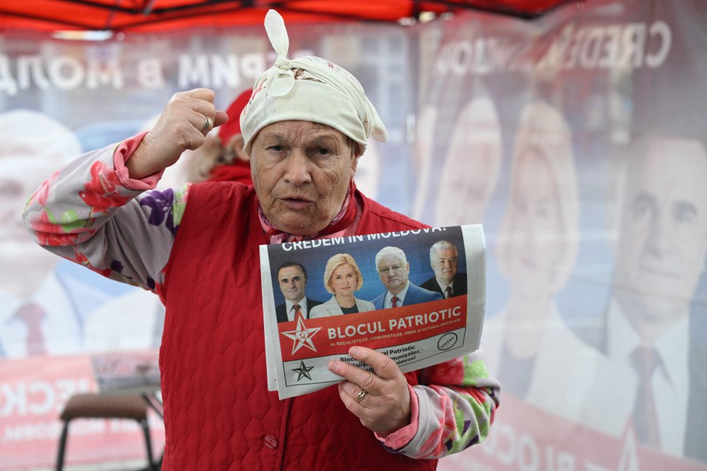 An elderly campaigner for the Patriotic Electoral Bloc (BEP), a pro-Russian left-wing alliance, gesticulates while distributing posters ahead of the parliamentary elections, in Chisinau, Moldova, on September 25, 2025. (Photo by Artur Widak via Getty Images)