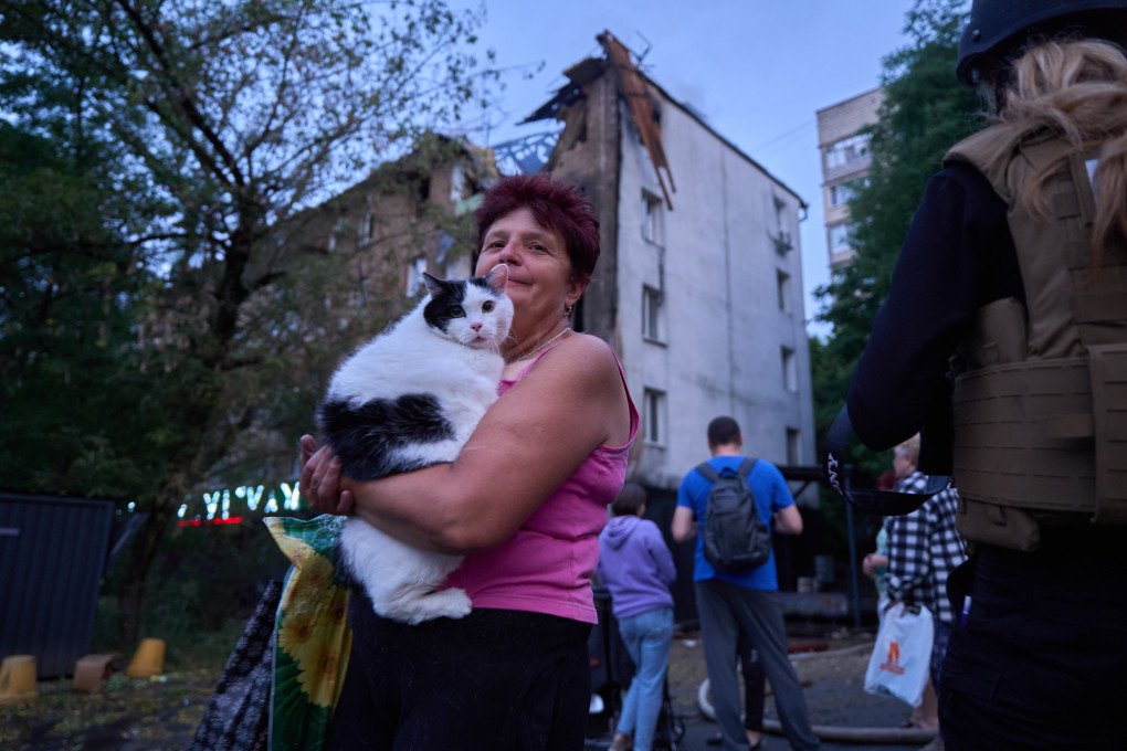 Woman holding her pet near a site of a Russian strike on a civilian house, Kyiv, July 10, 2025. (Source: UNITED24 Media)